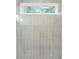 The shower has vertical subway tile, a window, and a transparent glass shower door at 2325 Mason Dr # D22, Atlanta, GA 30316