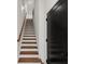 Bright staircase with wooden steps, white risers, and a modern handrail, leading to the upper level at 2325 Mason Dr # D22, Atlanta, GA 30316