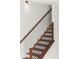 Modern staircase with wooden treads, black metal railings, and white walls at 2325 Mason Dr # D22, Atlanta, GA 30316