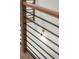 Modern staircase with wooden handrail and black metal balusters, complemented by stylish sconce lighting at 2325 Mason Dr # D22, Atlanta, GA 30316