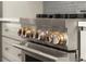 Eye-level shot of a stainless steel gas cooktop with decorative knobs and oven door at 2325 Mason Dr # D22, Atlanta, GA 30316