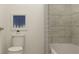 Cozy bathroom featuring a toilet, shower with tiled walls, and stylish decor, creating a functional space at 255 Deer Valley Run, Canton, GA 30115