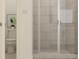 Tiled shower with glass door, toilet with modern design, and neutral color scheme in a bathroom at 255 Deer Valley Run, Canton, GA 30115