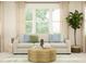 Inviting living room featuring a comfortable sofa, round coffee table, and abundant natural light at 255 Deer Valley Run, Canton, GA 30115