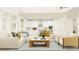 Open concept living room with contemporary furnishings, bright natural light, and seamless flow to the kitchen at 255 Deer Valley Run, Canton, GA 30115