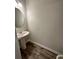 Half bath with wood-look flooring, pedestal sink, and modern faucet at 2832 Saratoga Lake Vw, Decatur, GA 30034