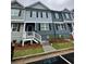 Charming two-story townhome featuring neutral siding, black shutters, and a welcoming front porch at 2832 Saratoga Lake Vw, Decatur, GA 30034