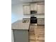 Modern kitchen with gray cabinets, stainless steel appliances, granite countertops, and wood floors at 2832 Saratoga Lake Vw, Decatur, GA 30034