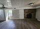 Unfinished basement featuring a stone fireplace, drop ceiling, new wood floors and walk-out doors at 3140 Kipling Dr, Powder Springs, GA 30127