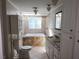 Bathroom featuring a jacuzzi tub, tile backsplash, double sinks and updated vanity at 3140 Kipling Dr, Powder Springs, GA 30127