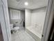 Basement bathroom featuring new toilet, vanity, tiled floor and shower with safety bar at 3140 Kipling Dr, Powder Springs, GA 30127