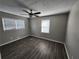 Cozy bedroom with fresh neutral paint, wood-look flooring, ceiling fan, and natural light from a large window at 3140 Kipling Dr, Powder Springs, GA 30127