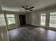 Neutral bedroom featuring new wood floors, ceiling fan, closet and a bright, glass-door sunroom at 3140 Kipling Dr, Powder Springs, GA 30127