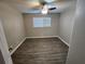 Cozy bedroom featuring wood-look flooring, fresh paint, ceiling fan, and lots of natural light from a window at 3140 Kipling Dr, Powder Springs, GA 30127