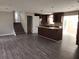 Open-concept kitchen with an island cooktop, stainless appliances, and hardwood floors at 3140 Kipling Dr, Powder Springs, GA 30127