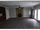 Bright living room featuring hardwood floors, brick fireplace and backyard access at 3140 Kipling Dr, Powder Springs, GA 30127