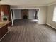 Open concept kitchen and living room featuring hardwood floors and a brick fireplace at 3140 Kipling Dr, Powder Springs, GA 30127