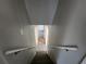 Bright stairwell leading to an unfinished basement, showing updated paint, handrails, and wood-look flooring at 3140 Kipling Dr, Powder Springs, GA 30127