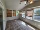 Bright sunroom features a vaulted ceiling with fan and many windows with bamboo blinds for privacy at 3140 Kipling Dr, Powder Springs, GA 30127