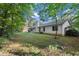 View of the home's backyard, featuring wooded surroundings and a patio at 11006 Clearwater Dr, Hampton, GA 30228