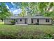 Wide view of the home's backyard featuring a concrete patio and lush green surroundings at 11006 Clearwater Dr, Hampton, GA 30228