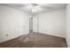 Bedroom with neutral carpet, ceiling fan, and multiple doorways at 11006 Clearwater Dr, Hampton, GA 30228