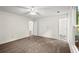 Spacious bedroom with neutral carpet, ceiling fan, and natural light at 11006 Clearwater Dr, Hampton, GA 30228