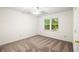Bedroom featuring neutral carpet and a window offering natural light at 11006 Clearwater Dr, Hampton, GA 30228