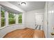 Bright dining area with a large window, hardwood floors, and wainscotting at 11006 Clearwater Dr, Hampton, GA 30228