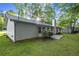 Home exterior featuring a concrete patio, lush greenery, and a chimney at 11006 Clearwater Dr, Hampton, GA 30228