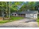 Exterior shot of a charming home, showcasing red shutters, brick accents, and an attached garage with driveway at 11006 Clearwater Dr, Hampton, GA 30228