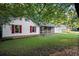 Cozy single-story home featuring red shutters and a charming front porch, nestled in a wooded lot at 11006 Clearwater Dr, Hampton, GA 30228