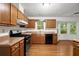 Kitchen features stainless steel appliances, wooden cabinets, and a bay window at 11006 Clearwater Dr, Hampton, GA 30228