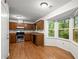 Bright kitchen features hardwood floors, stainless steel appliances, and a bay window with a wooded view at 11006 Clearwater Dr, Hampton, GA 30228