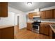 Functional kitchen with wooden cabinets and stainless steel range at 11006 Clearwater Dr, Hampton, GA 30228