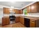 Kitchen boasts stainless steel appliances, wooden cabinets, and a light countertop at 11006 Clearwater Dr, Hampton, GA 30228