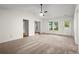 Bright living room with neutral carpet, ceiling fan, and natural light from windows at 11006 Clearwater Dr, Hampton, GA 30228