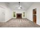 Bright living room with vaulted ceilings, brick fireplace, neutral carpet, and natural light from the windows at 11006 Clearwater Dr, Hampton, GA 30228