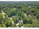 Wide aerial shot of the house nestled in a lush green neighborhood with mature trees at 1208 Brandl Sw Dr, Marietta, GA 30008