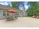 Back patio with an outdoor dining set and grill, perfect for entertaining guests at 1208 Brandl Sw Dr, Marietta, GA 30008