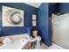 Bathroom with soaking tub, glass shower, and dark blue walls at 1208 Brandl Sw Dr, Marietta, GA 30008