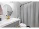 Updated bathroom features a stylish gray vanity with gold hardware and a round mirror at 1208 Brandl Sw Dr, Marietta, GA 30008