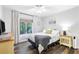 Cozy bedroom with wood floors, a ceiling fan, and a large window with natural light at 1208 Brandl Sw Dr, Marietta, GA 30008