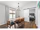 Inviting dining area features a stylish chandelier and a sliding barn door leading to a bedroom at 1208 Brandl Sw Dr, Marietta, GA 30008