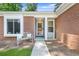 Inviting front porch with a cozy bench, decorative pillows, and a 'Welcome' sign at 1208 Brandl Sw Dr, Marietta, GA 30008