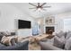 Bright living room boasts a fireplace, ceiling fan, and neutral color palette for a cozy atmosphere at 1208 Brandl Sw Dr, Marietta, GA 30008