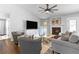 Cozy living room with a fireplace, ceiling fan, TV, and comfortable seating for relaxation and entertainment at 1208 Brandl Sw Dr, Marietta, GA 30008
