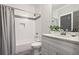 Bright bathroom with a shower-tub combination featuring tiled walls, sleek fixtures, and a vanity at 1297 Conway Rd, Decatur, GA 30030