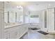 Serene bathroom with double vanity, free standing tub and a glass enclosed walk-in shower with tile accent wall at 1297 Conway Rd, Decatur, GA 30030