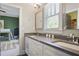 Bright, modern bathroom featuring dual sinks and large mirror, with view to adjacent bedroom at 1297 Conway Rd, Decatur, GA 30030